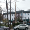 Tne new pole is the light-colored one in the center of the image. There are no wires on it yet.
